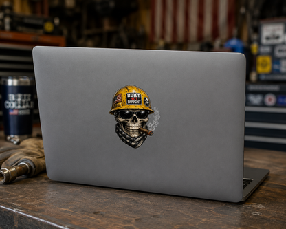 Laptop with a skull wearing a hard hat sticker on a wooden surface.