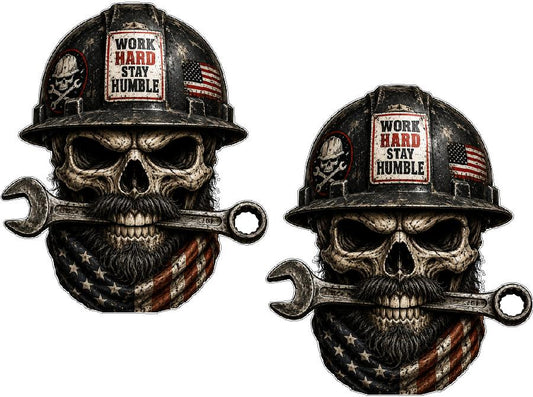 Two skull designs wearing hard hats with American flags and 'Work Hard Stay Humble' text, holding wrenches.