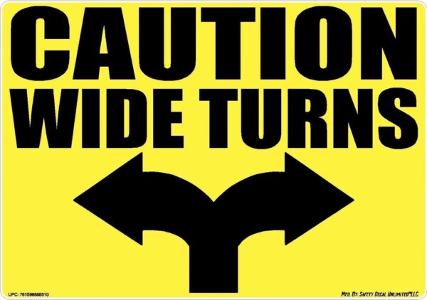 A yellow sign with black arrows and the words caution wide turns.