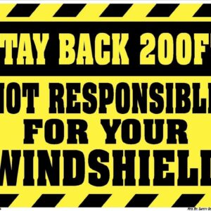 A yellow and black sign that says stay back 2 0 0 feet not responsible for your windshield.