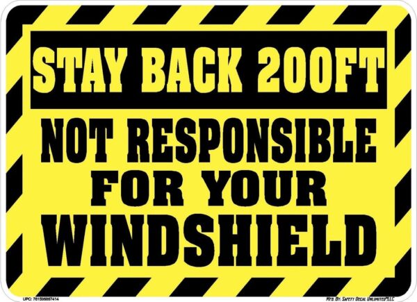 A yellow and black sign that says stay back 2 0 0 feet not responsible for your windshield.