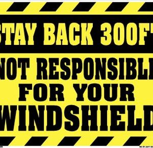 A yellow sign that says stay back 3 0 0 feet not responsible for your windshield.